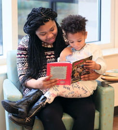 Mom reads with her child.